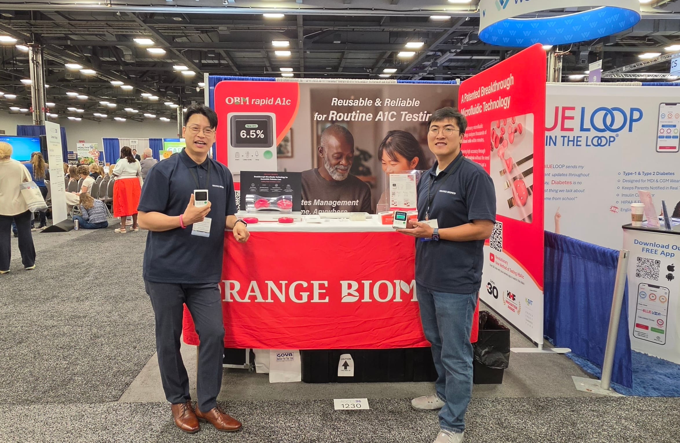 Orange Biomed team showcasing its A1C testing technology at the ADCES 2026 exhibition booth